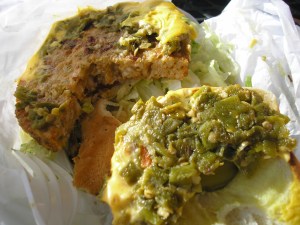 Layer of chile and cheese on burger.